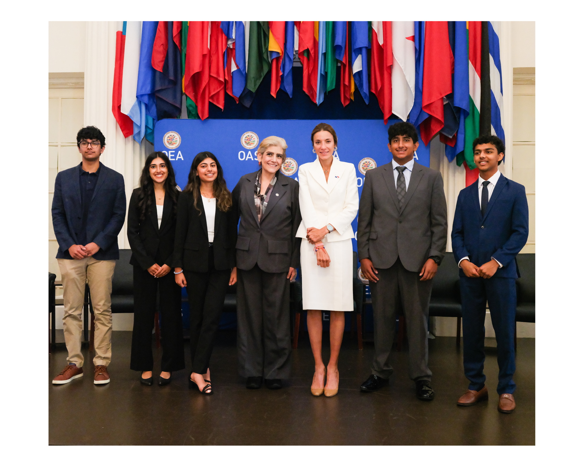 IYLC students standing together in front of the flags of the member states